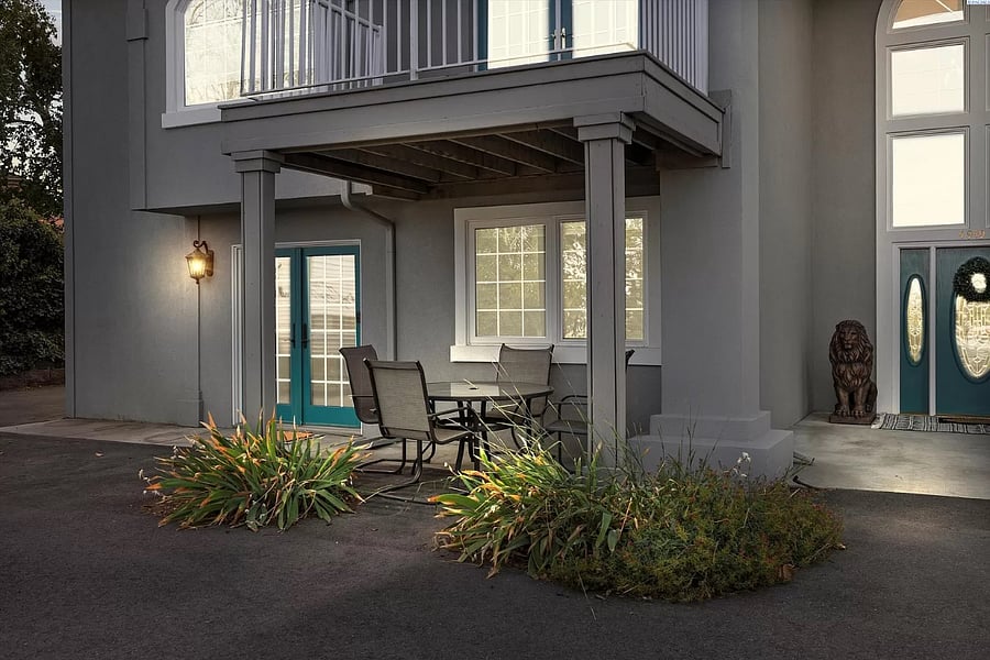 Private entry way with patio space and green space on the left sideK