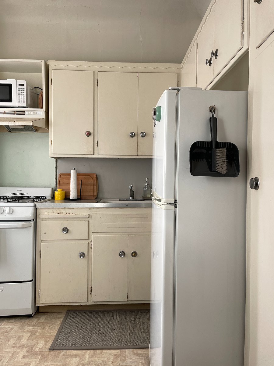 Kitchen has plenty of cabinet space and a full-sized fridge.