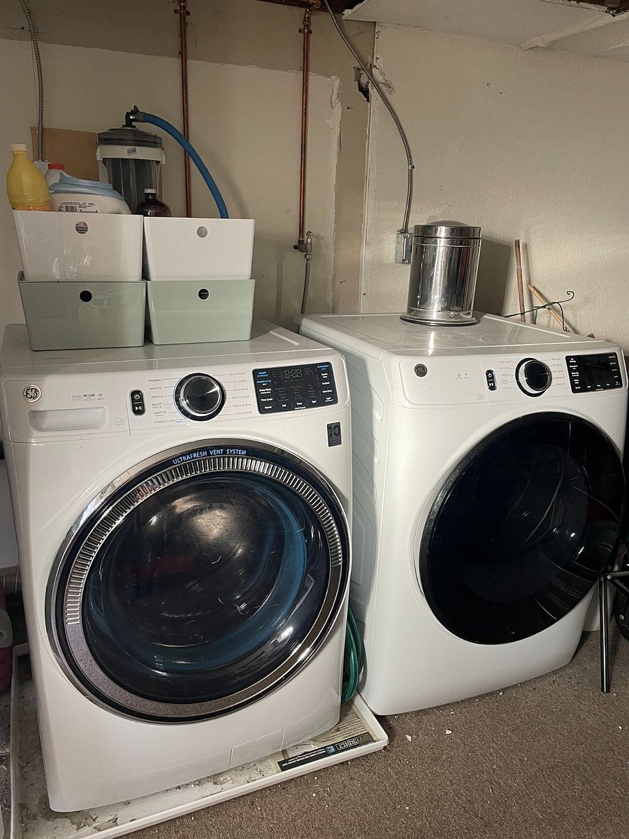 Shared laundry room in storage room under unit.