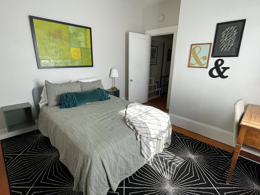 Bedroom includes full bed and desk, with two large closets.