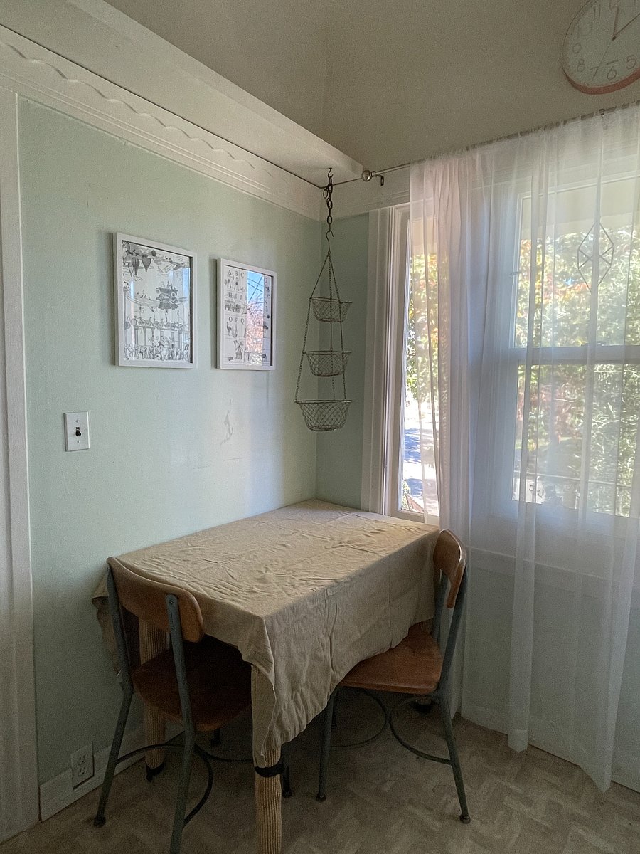 Kitchen with table and chairs for extra work space and dining. Windows are east facing and have beautiful morning light.