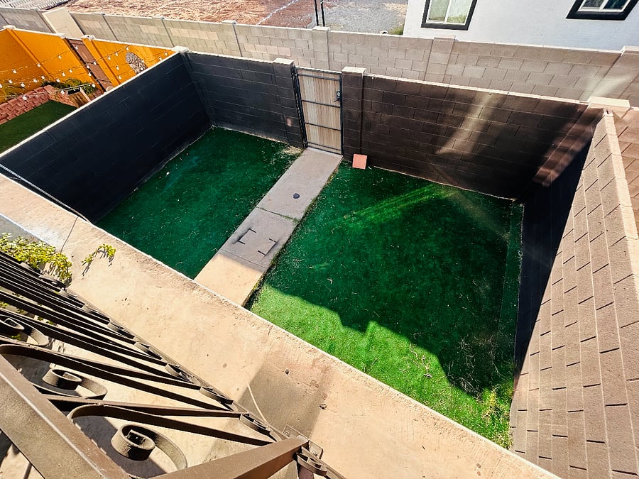 View of front yard from second floor showing perimeter fence and walkway from street to enter.