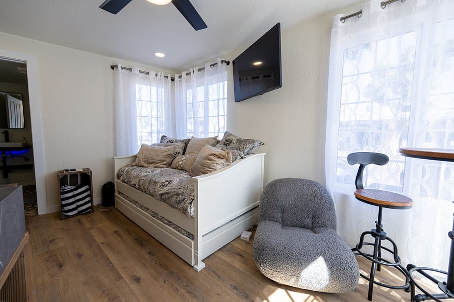 Comfortable bed with trundle and comfortable chair to enjoy sitting and reading as you enjoy the outside breeze or for watching the smart tv