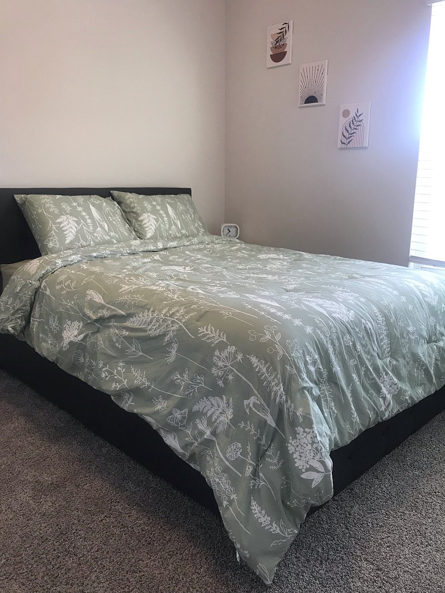 Brand new full sized bed, mattress and comforter set. Nightstand and clock next to bed.