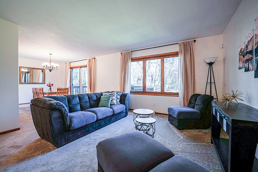 Sitting room and dining room provide view of outdoor green space.
