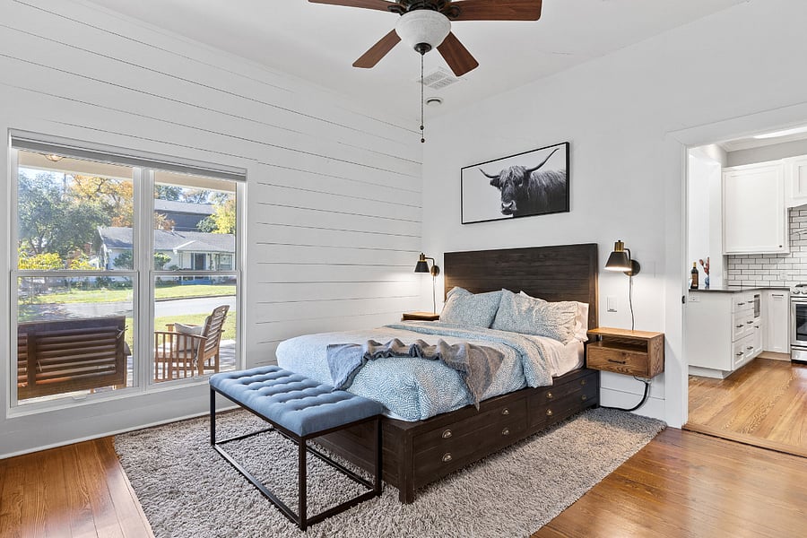 Primary bedroom with abundant space for hanging clothes in closets to the right of door; bed recently upgraded to a king