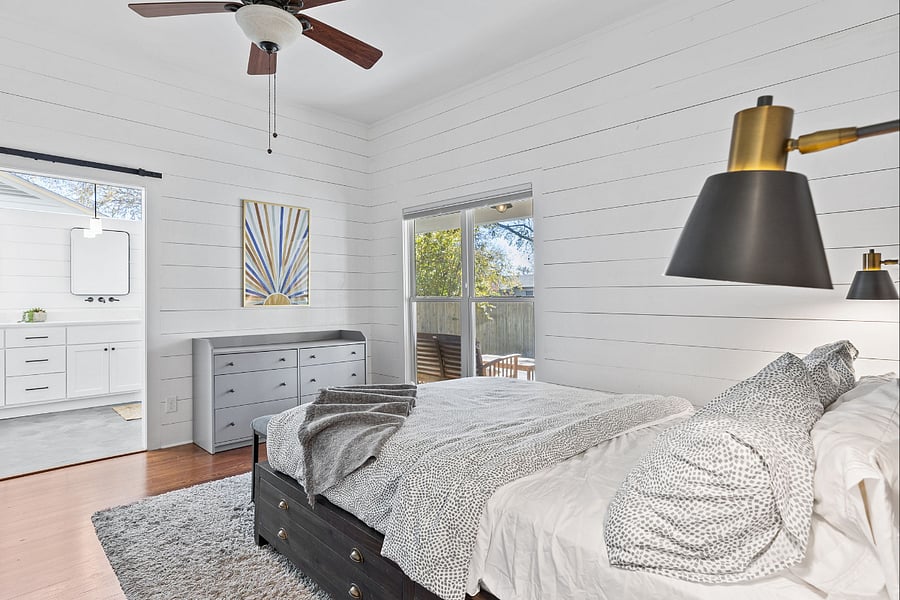 Large sliding barn door into bathroom with giant mirror