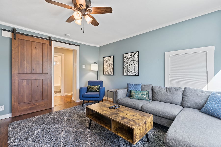 Media room has sliding barn door for privacy and noise reduction