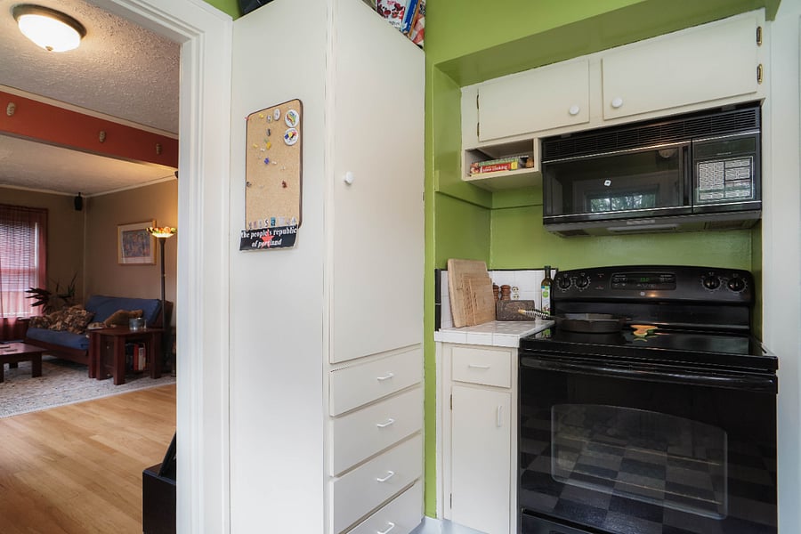 kitchen leads to dining room. Electric oven and stovetop with microwave