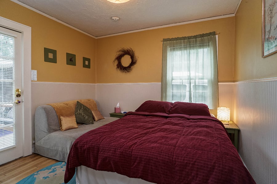 south facing bedroom is sunny and hosts a private entrance to the backyard