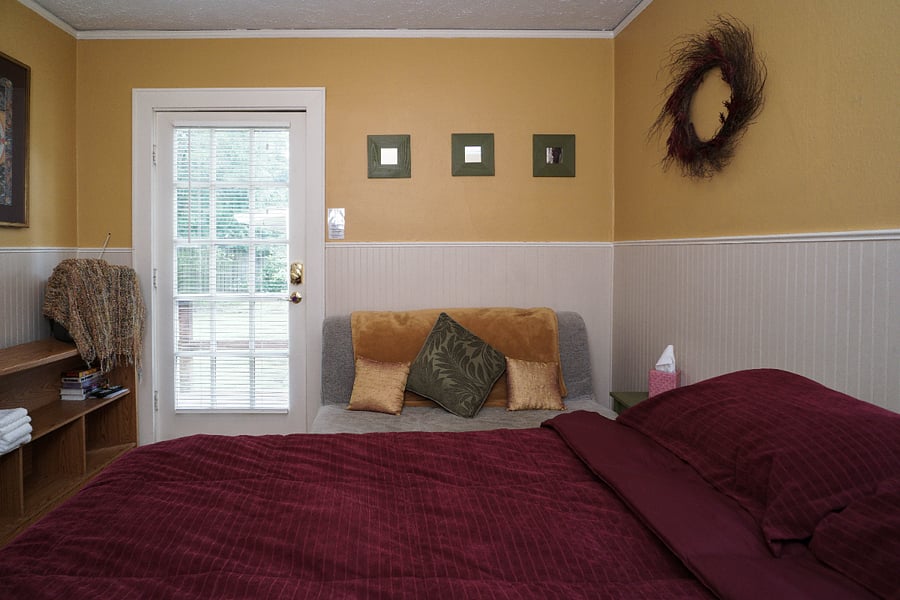 south facing bedroom is sunny and hosts a private entrance to the backyard