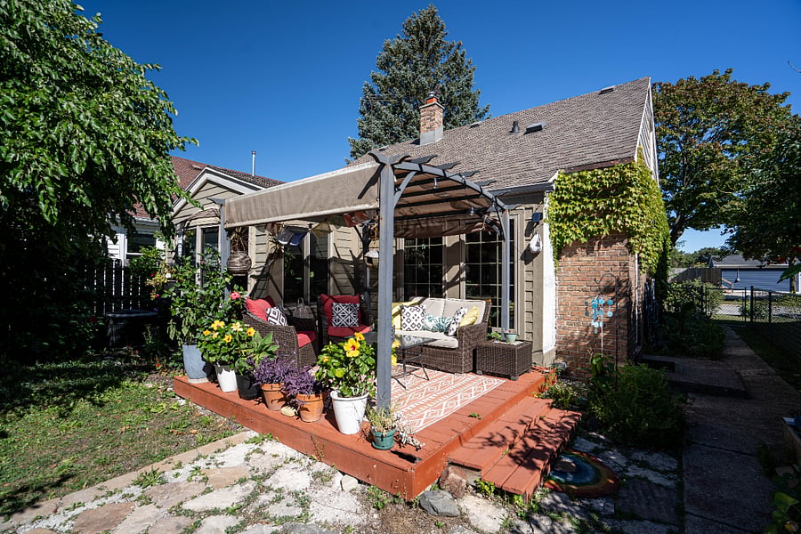 Outdoor patio area with gas grill. 