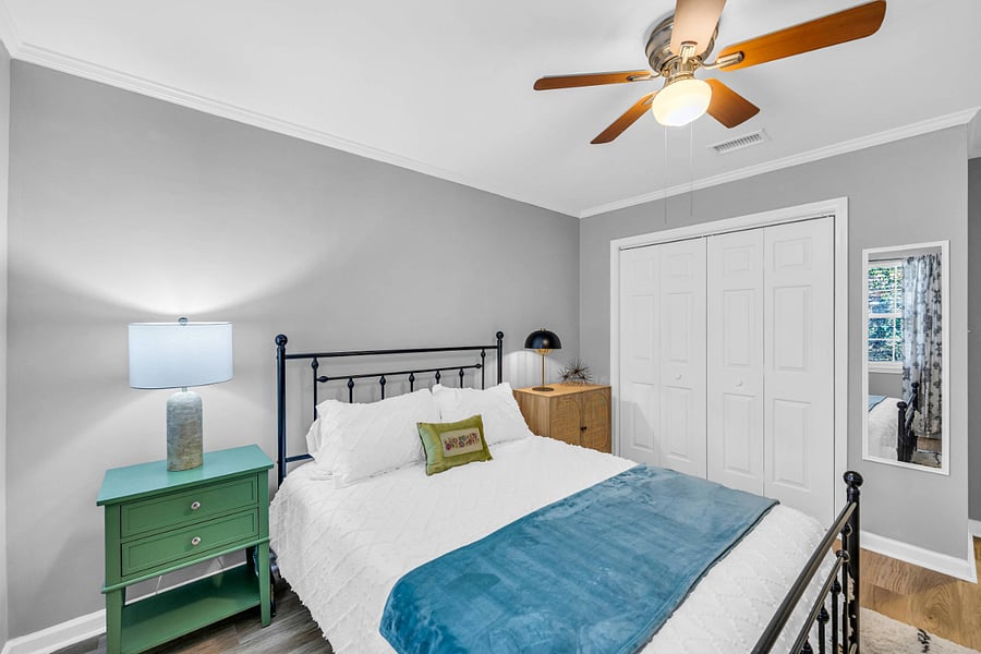 Second Queen Bedroom at Back of Unit with Black Iron Frame. Full Closet. 