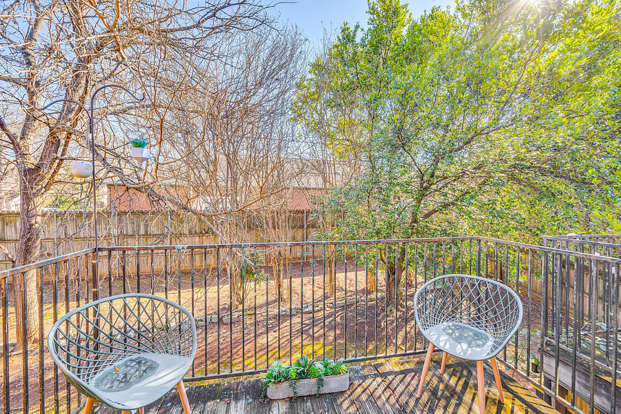 Back deck surrounded by trees.