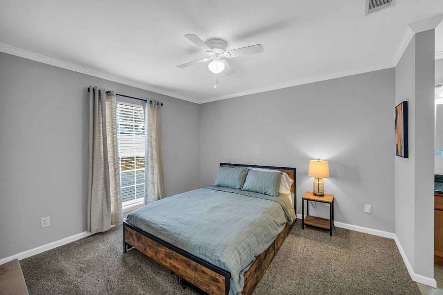 Front bedroom with queen bed and storage drawers.