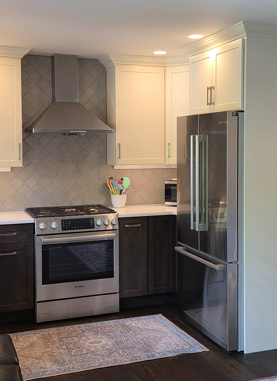View of full-size fridge, microwave, and stove/oven.