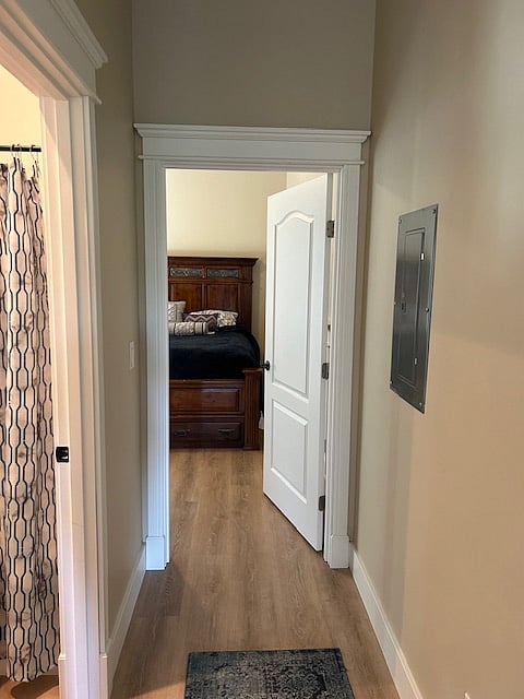 Hallway leading from front room to bedroom, near bathroom.