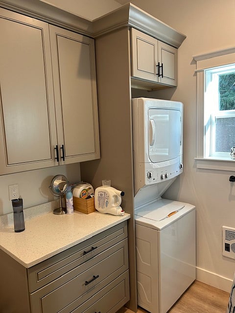 Laundry washer and dryer are located in bathroom. There is also ample storage.