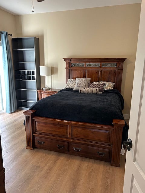 Bedroom with queen bed. Has slider door with great forest view.