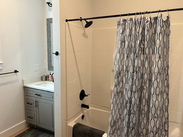 Bathroom with tub shower combo.