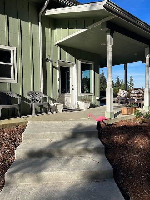 Covered patio with seating and BBQ.