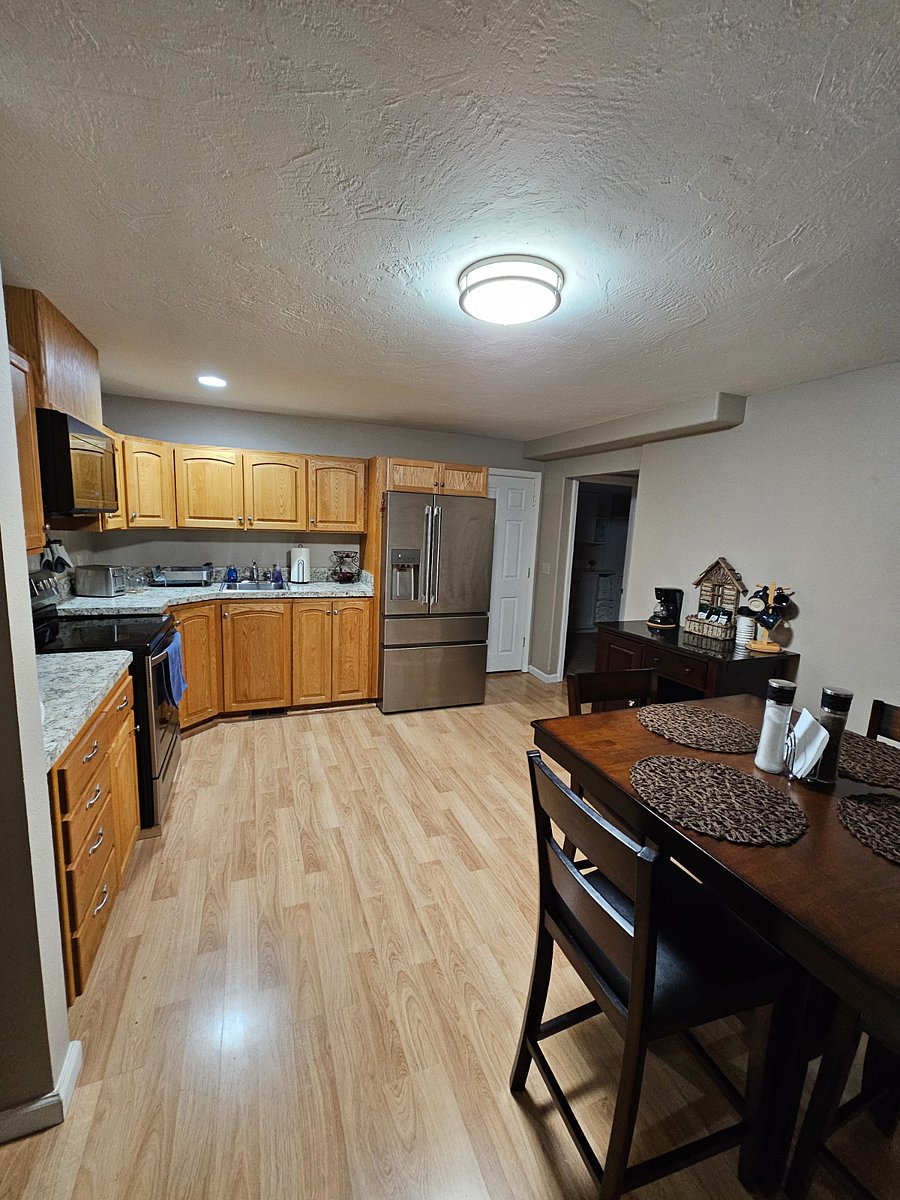 Inside kitchen, table for four and coffee station.