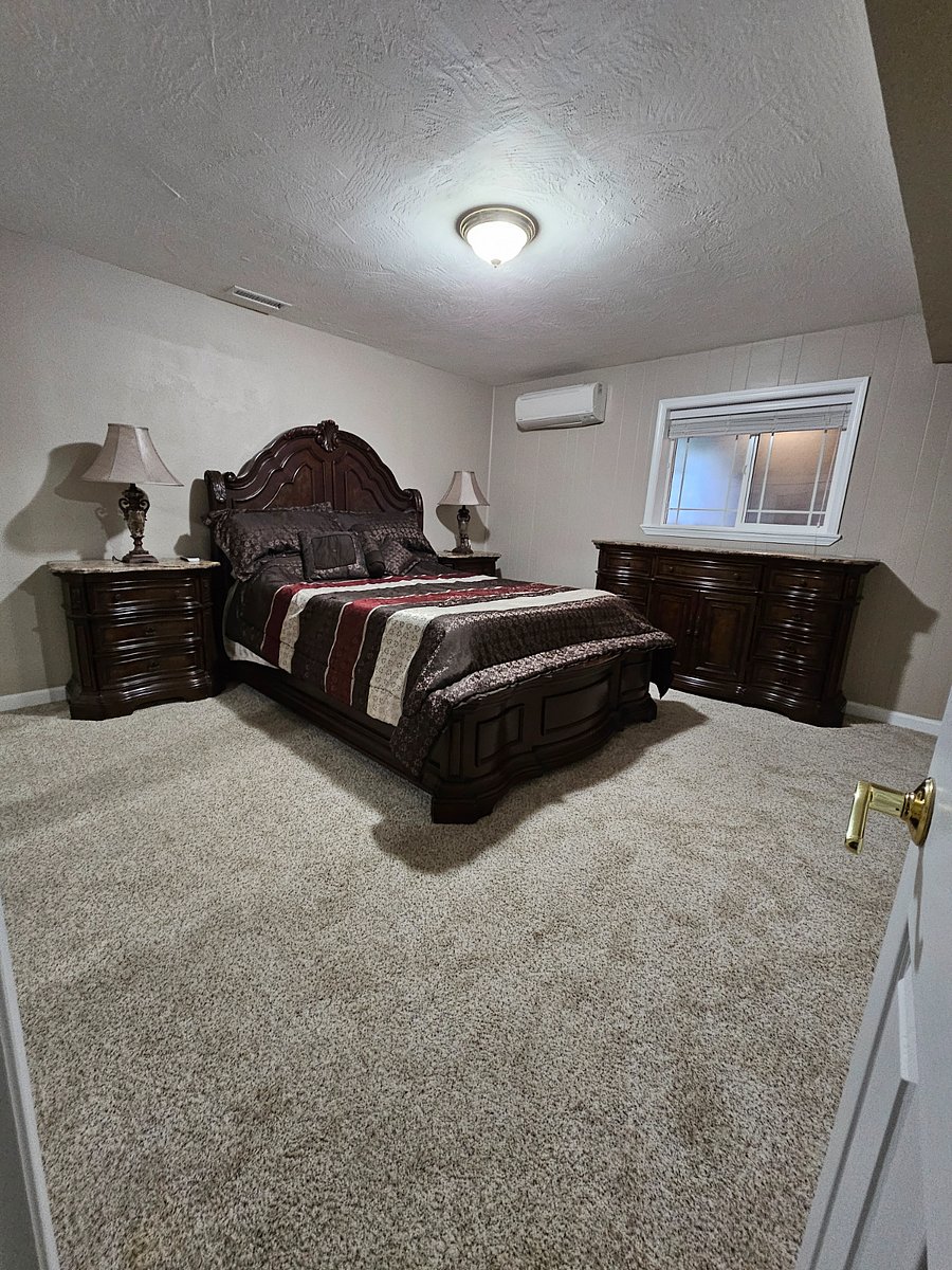 Master bedroom with queen bed. Adjustable bed with vibration and light settings. Wireless phone and watch charger.