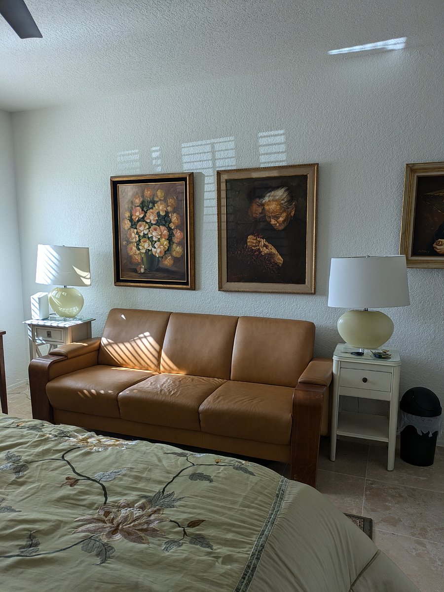 LEATHER COUCH WITH TWO(2) LAMP TABLES AND TWO(2) LAMPS, ART IN THE LARGER BEDROOM