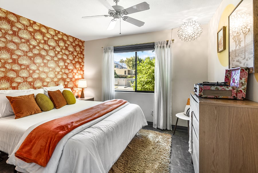secondary bedroom with king bed and pack n play