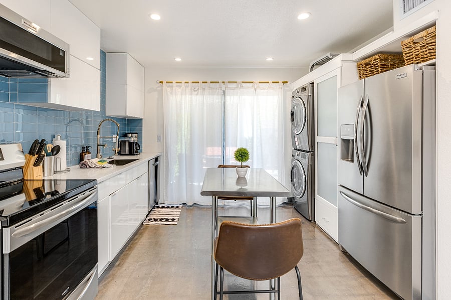 fully stocked kitchen with workspace and appliances. Washer and dryer for convenience