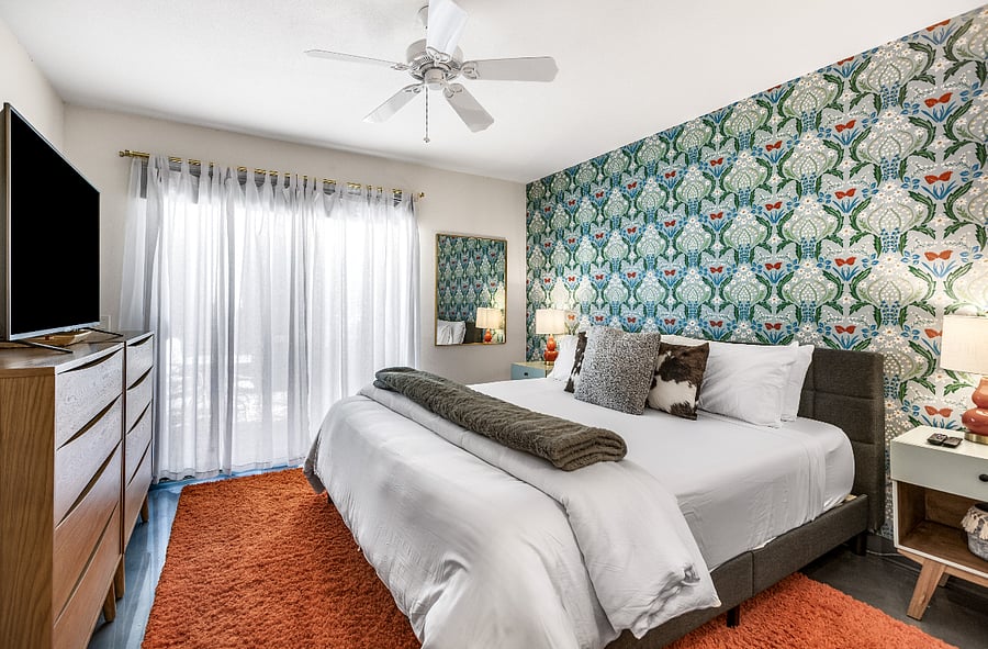 primary bedroom with insuite bathroom, including king bed and walk out to back patio.