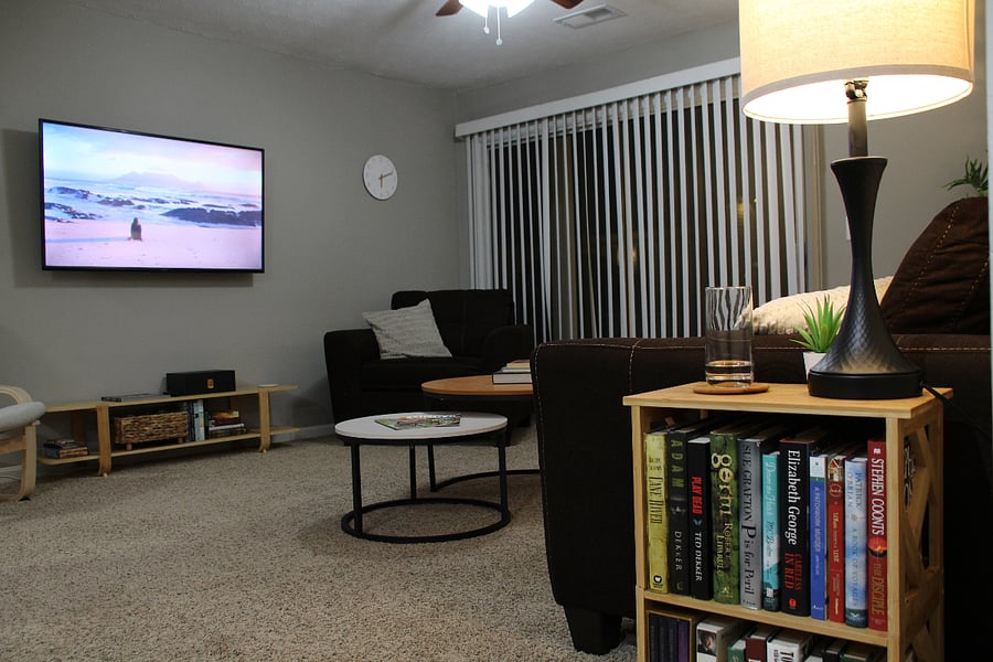 Comfortable living room sofa and chair, and 55" Smart 4K TV for easy streaming with built-in Apple Airplay, Google Chromecast, and 500 Mbps WiFi.