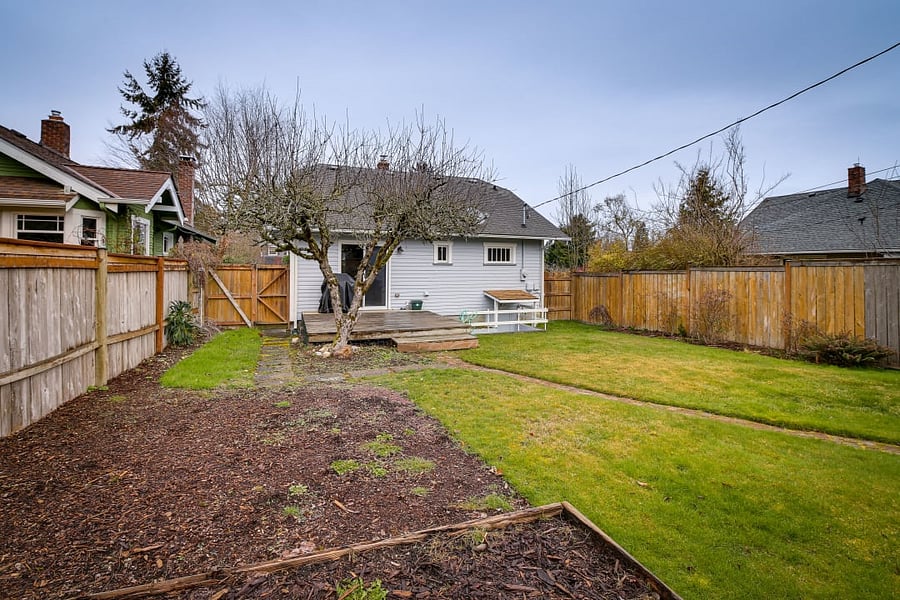 Fenced backyard with deck off the kitchen.