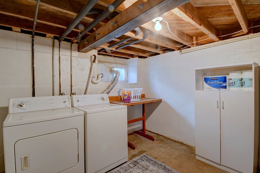 Downstairs laundry room with washer, dryer and folding table. Conveniently located inside the house.