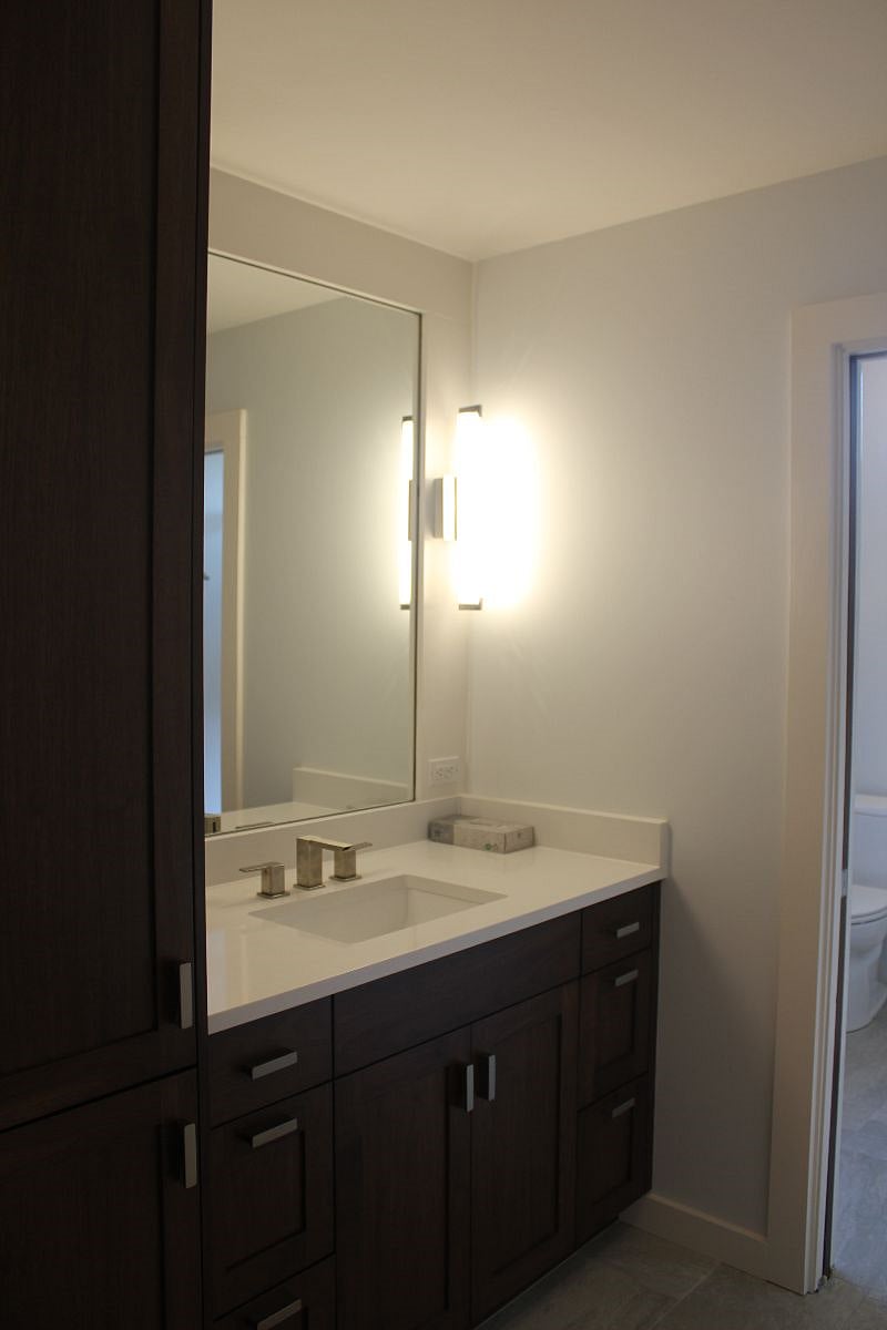 Bathroom vanity with linen closet.