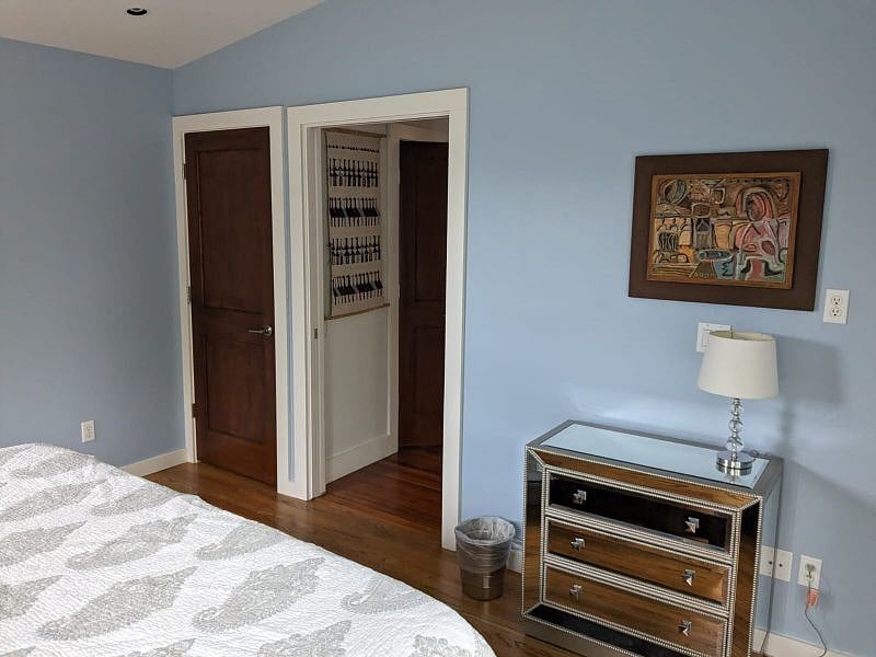 Bedroom closet, hallway to bathroom, and small dresser