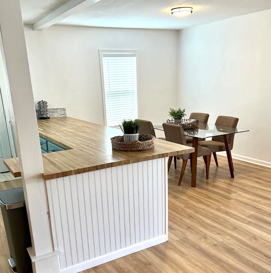 Kitchen with dining table and bar with barstools