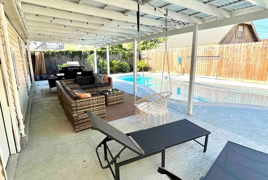 Backyard with lounge, outdoor dining set, and pool