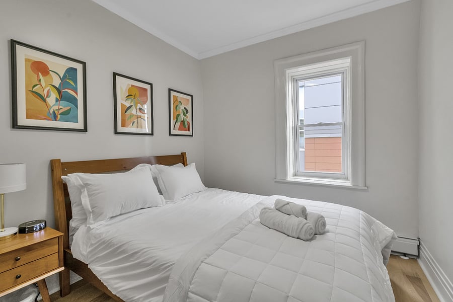 Cozy bedroom appointed with brightly colored art
