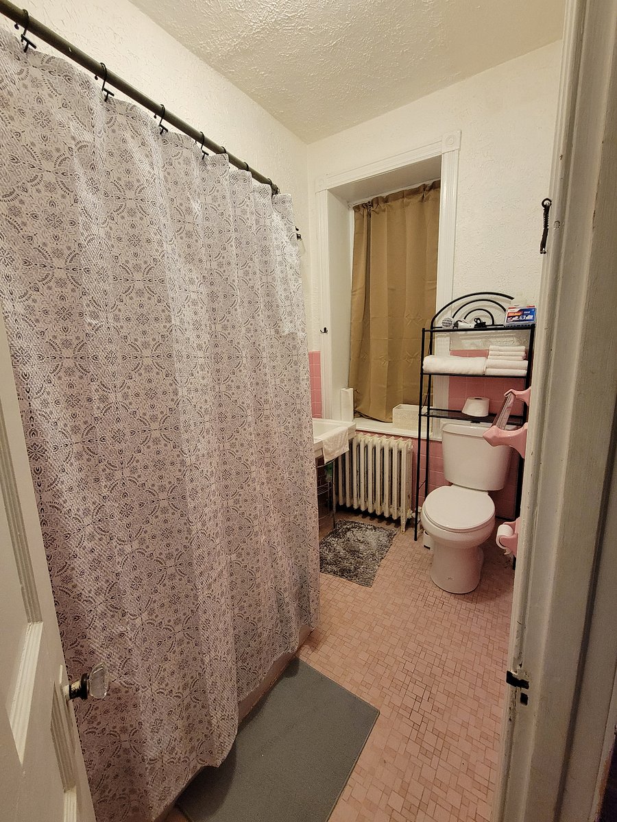 Full bathroom with tub, rain shower head and with great abundant in natural light, entered from kitchen.
