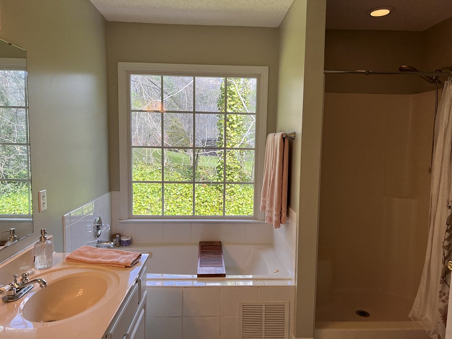 primary bathroom is ensuite to primary bedroom. Jetted tub, separate shower, walk-in closet.