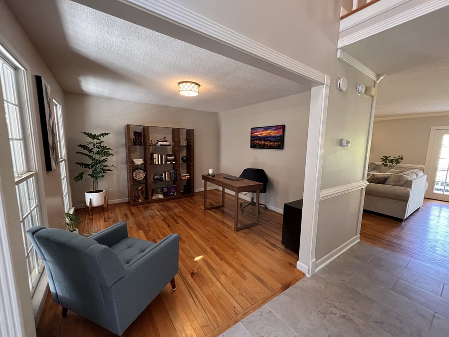 Office is at the front of the house with hallway leading to the living room and kitchen in the back of the house.