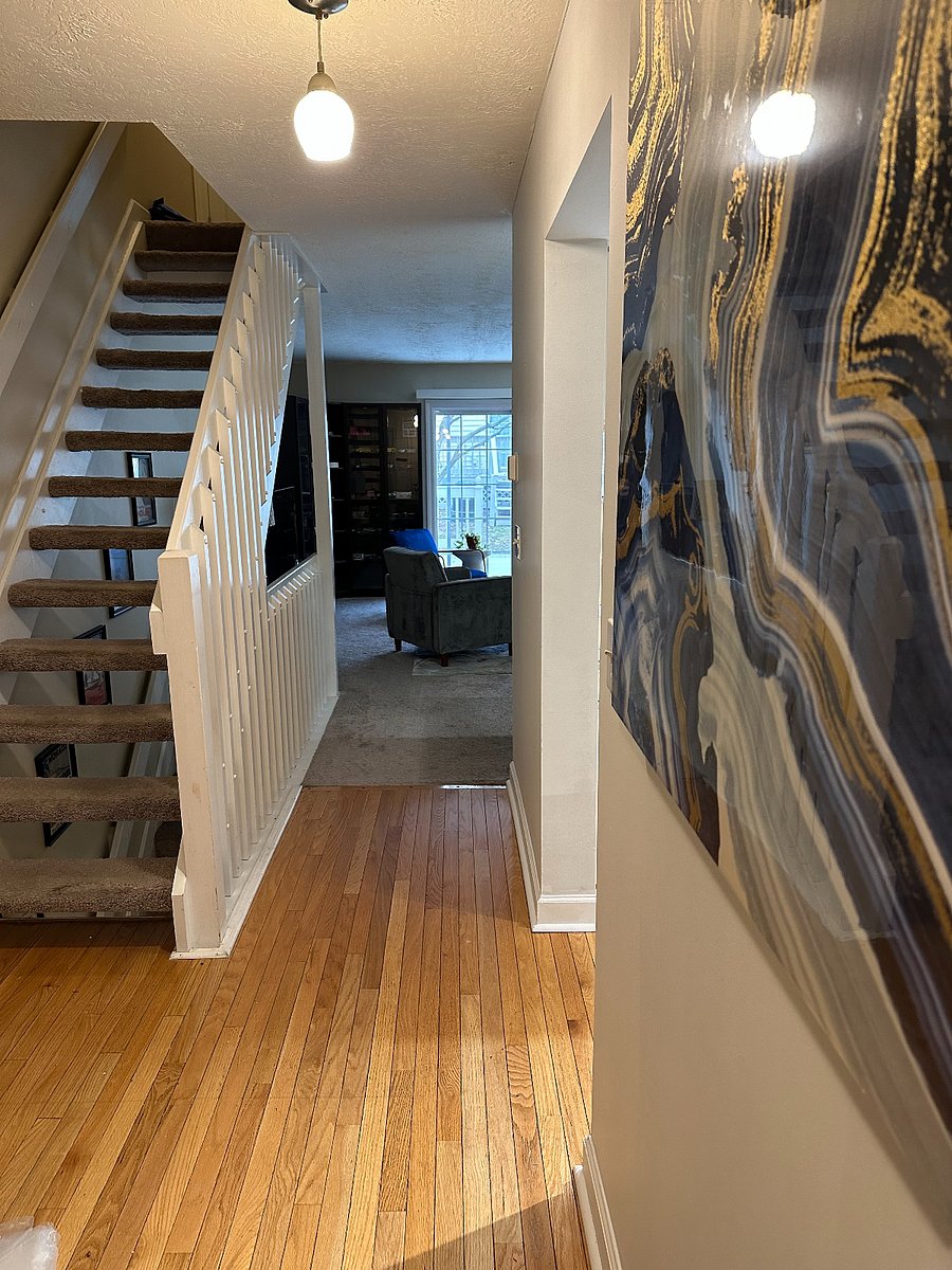 Spacious entry way with shoe storage bench, coat closet, half bath, and door to 2 car garage.