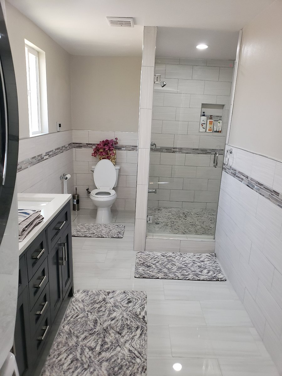 Spacious bathroom with glass door and shower head