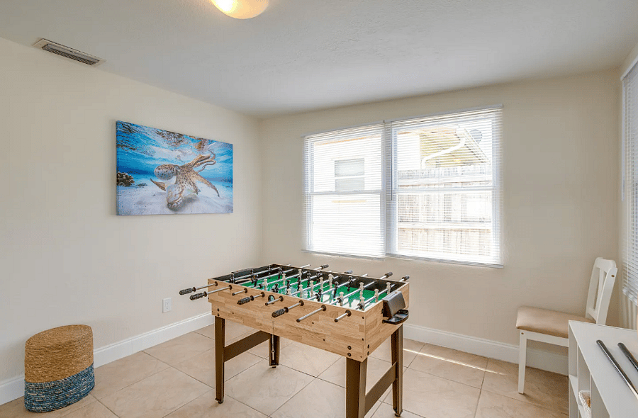 Gameroom with Foosball table for family fun and friendly competition.