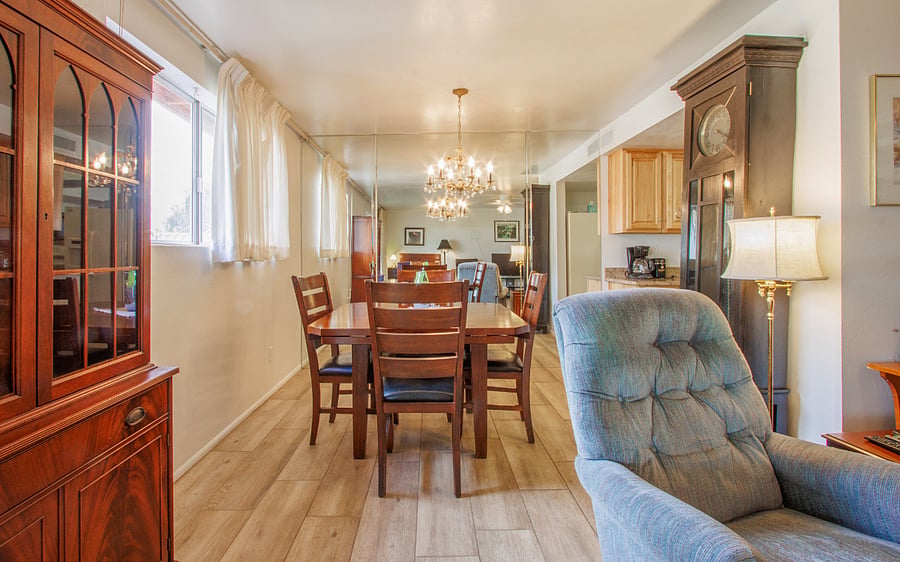 There is a glass covered mirrored wall on E side of dining room so a little hard to see. You are close to sliding door on N side of living room that opens to patio area.