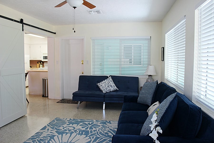 Sunroom - 3rd bedroom for guests. Barn doors for privacy and laundry room and armoire serves as closet.