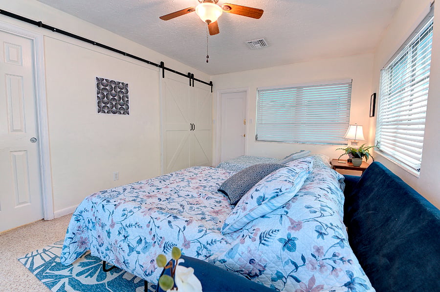 Sunroom as 3rd bedroom for guests - Queen sleeper sofa and Twin Futon bed sleeps 3. Barn doors for privacy and laundry room and armoire serves as closet.