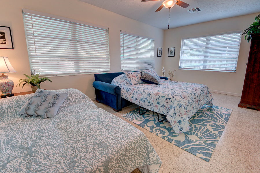 Sunroom as 3rd bedroom for guests - Queen sleeper sofa and Twin Futon bed sleeps 3. Barn doors for privacy and laundry room and armoire serves as closet.