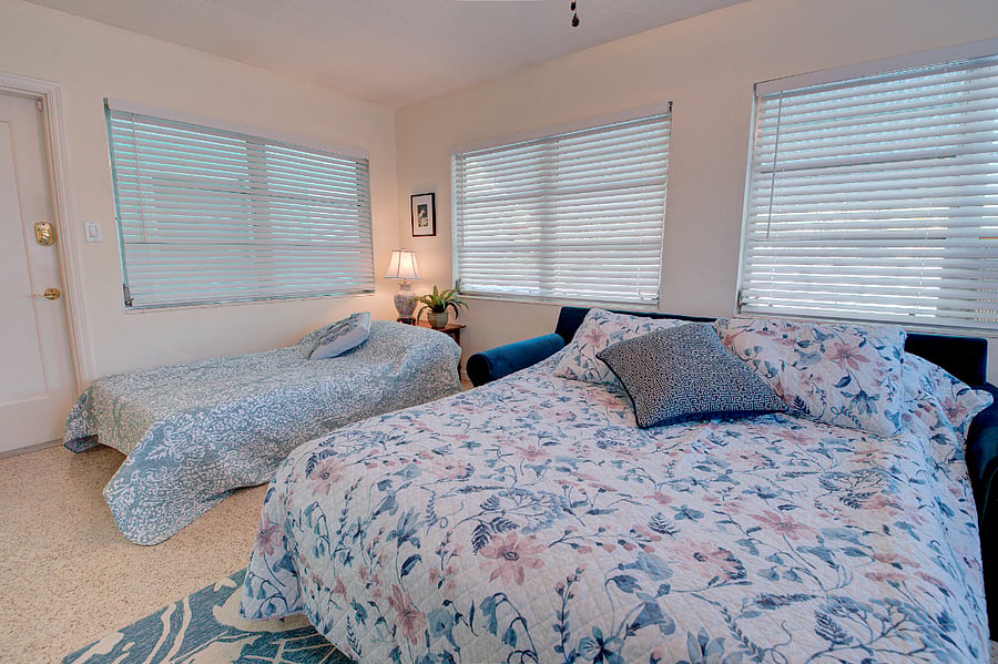 Sunroom as 3rd bedroom for guests - Queen sleeper sofa and Twin Futon bed sleeps 3. Barn doors for privacy and laundry room and armoire serves as closet.